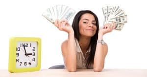 young woman holding fans of money with a clock nearby to signify personal finance for women